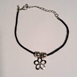 black bracelet with silver flower and beads